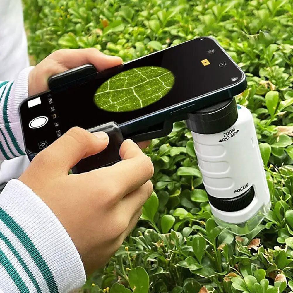 Kids digital microscope with IPS screen attached to a smartphone, white handheld scope examining a leaf on Tampa Home & Garden Store