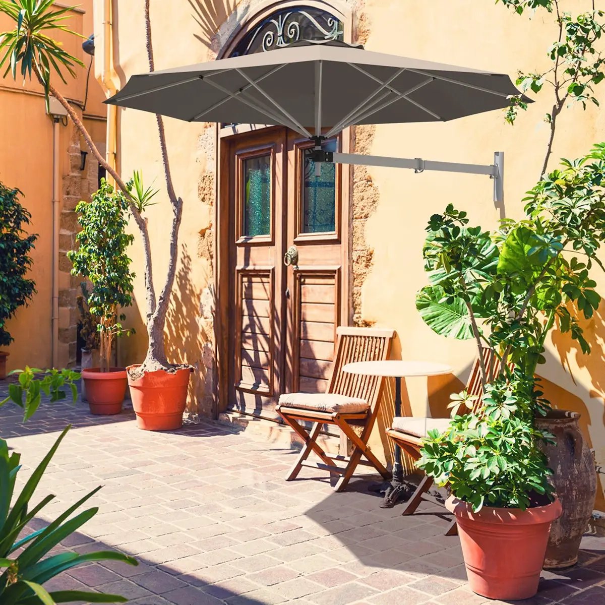 Wall Mounted Telescopic Tilt Shade Umbrella with gray canopy over a sunny patio on Tampa Home & Garden Store