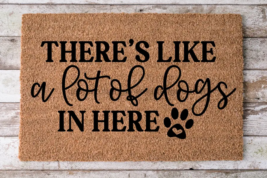 Coir dog door mat 30x18 with bold black text there's a lot of dogs in here and a paw print on Tampa Home & Garden Store
