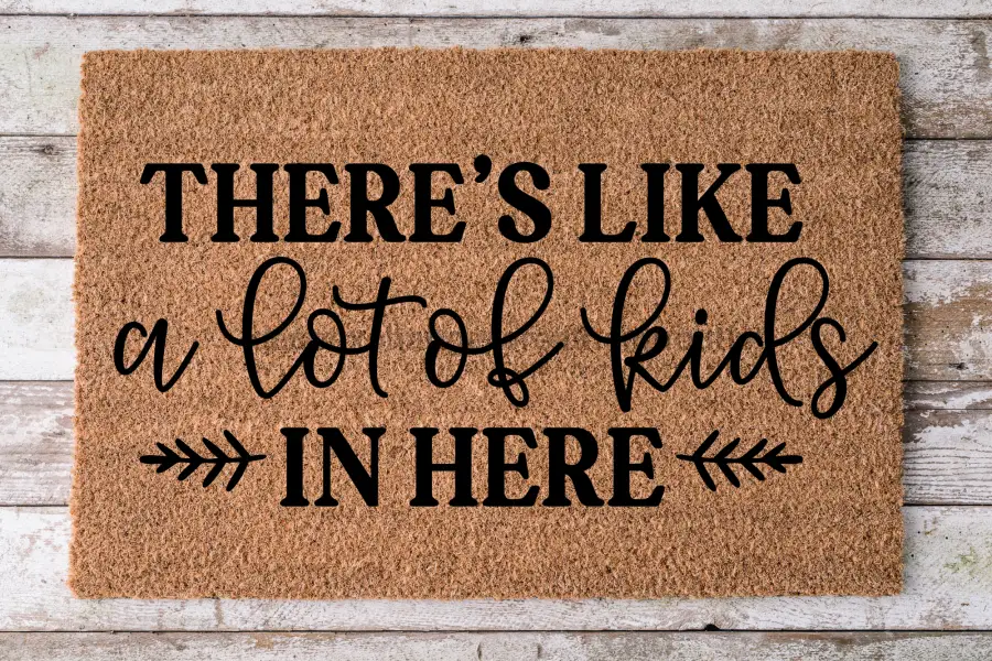 Coir door mat featuring bold black text THERE'S LIKE a lot of kids IN HERE DecoExchange brand 30x18 inches on Tampa Home & Garden Store