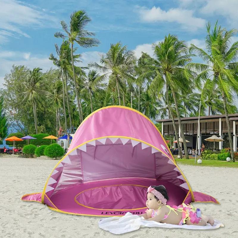 Children's Beach Tent pink with yellow trim provides sun shade on sandy beach on Tampa Home & Garden Store