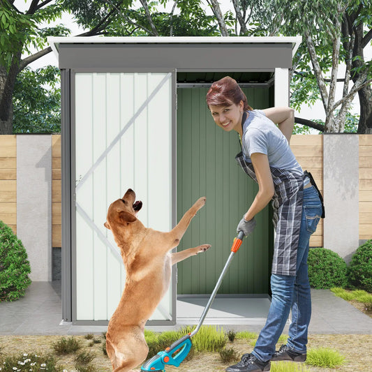 5x3ft outdoor storage shed with sloped roof in gray panels, with one person and one dog nearby on Tampa Home & Garden Store