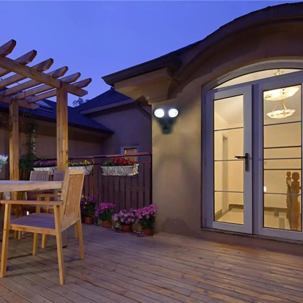 Solar Motion Sensor LED Light with Rotating Heads outdoor security lamp on wall by door on Tampa Home & Garden Store