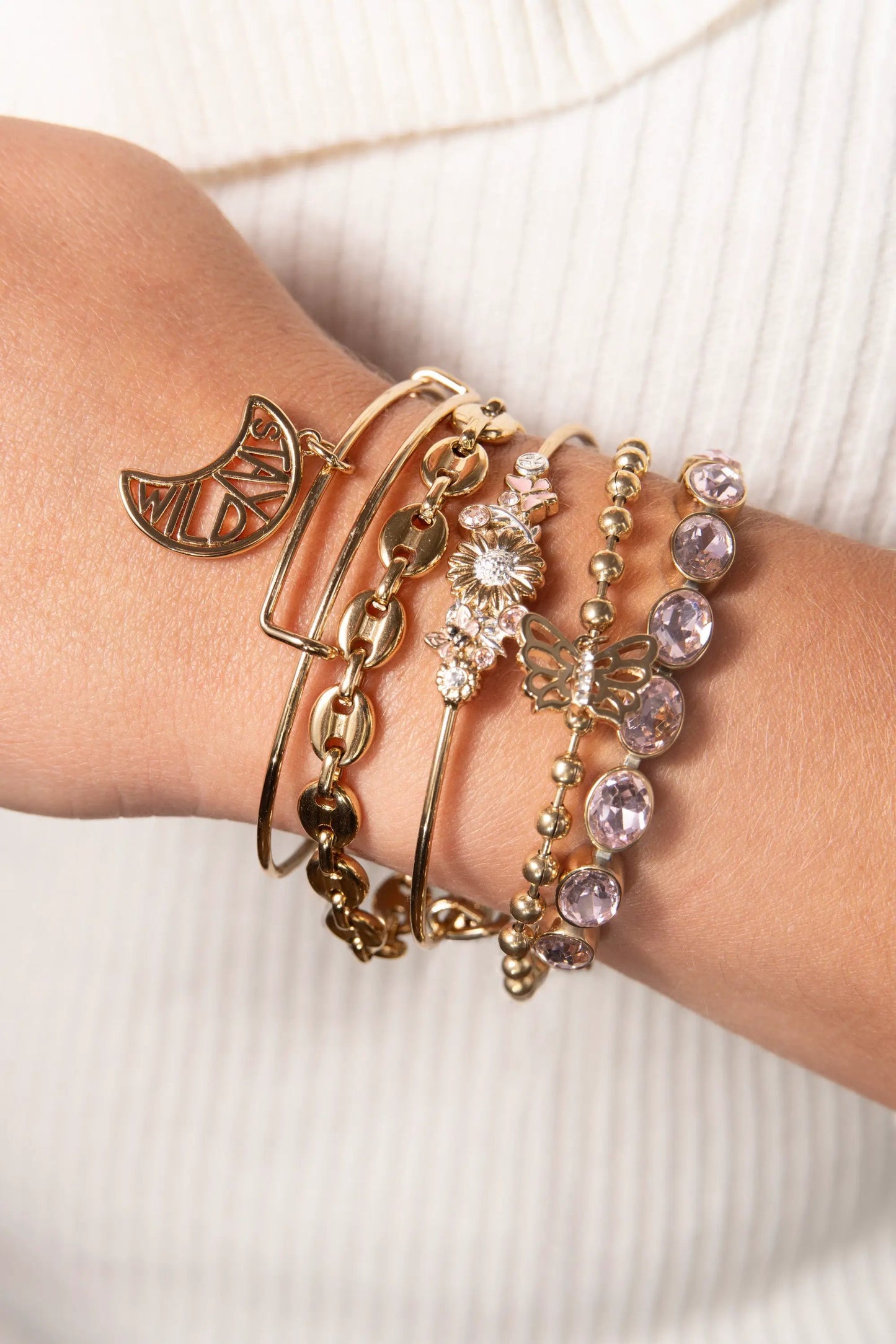 Butterfly Ball Chain Bracelet by Alex and Ani on wrist among gold-tone charm bracelets on Tampa Home & Garden Store