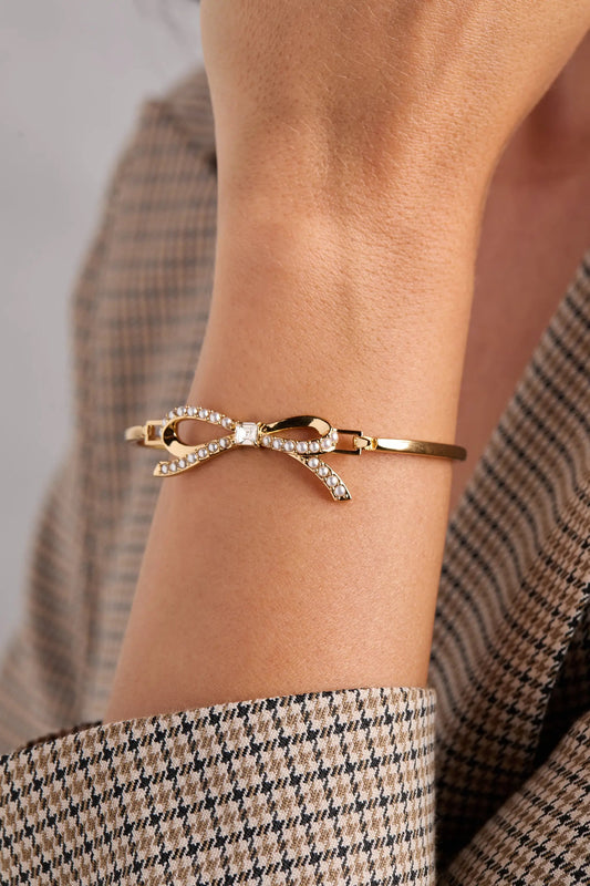 Bow Pearl Coquette Tension Bangle bracelet gold tone with pearl-accented bow ALEX AND ANI on Tampa Home & Garden Store