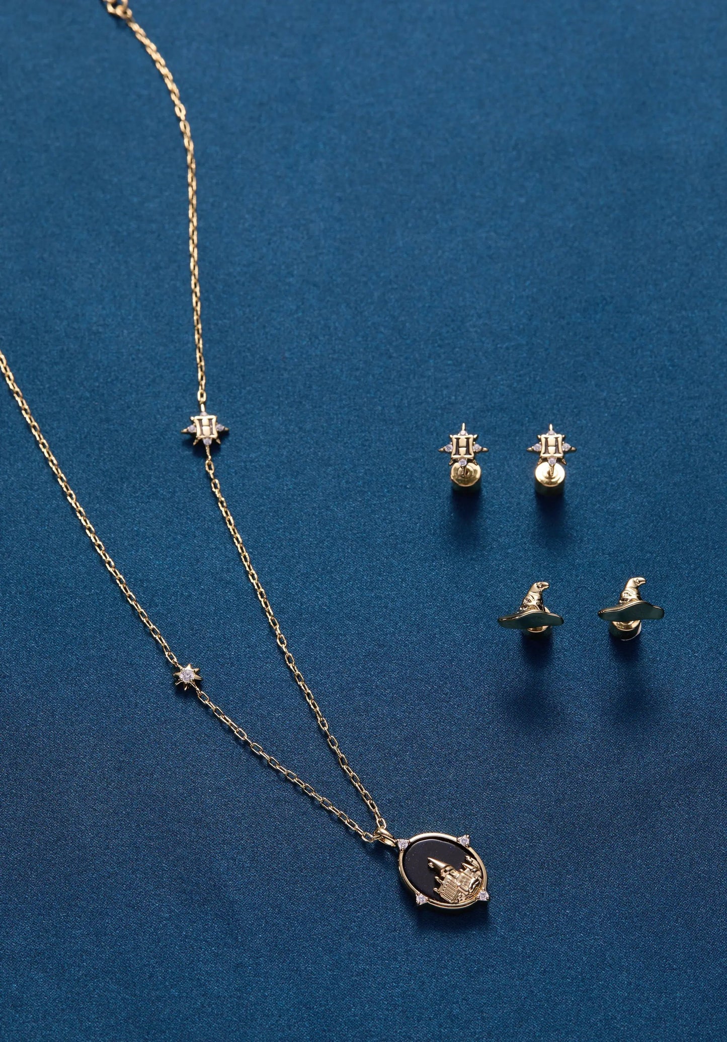 Harry Potter Hogwarts earrings with Sorting Hat star accents and crest necklace on blue on Tampa Home & Garden Store
