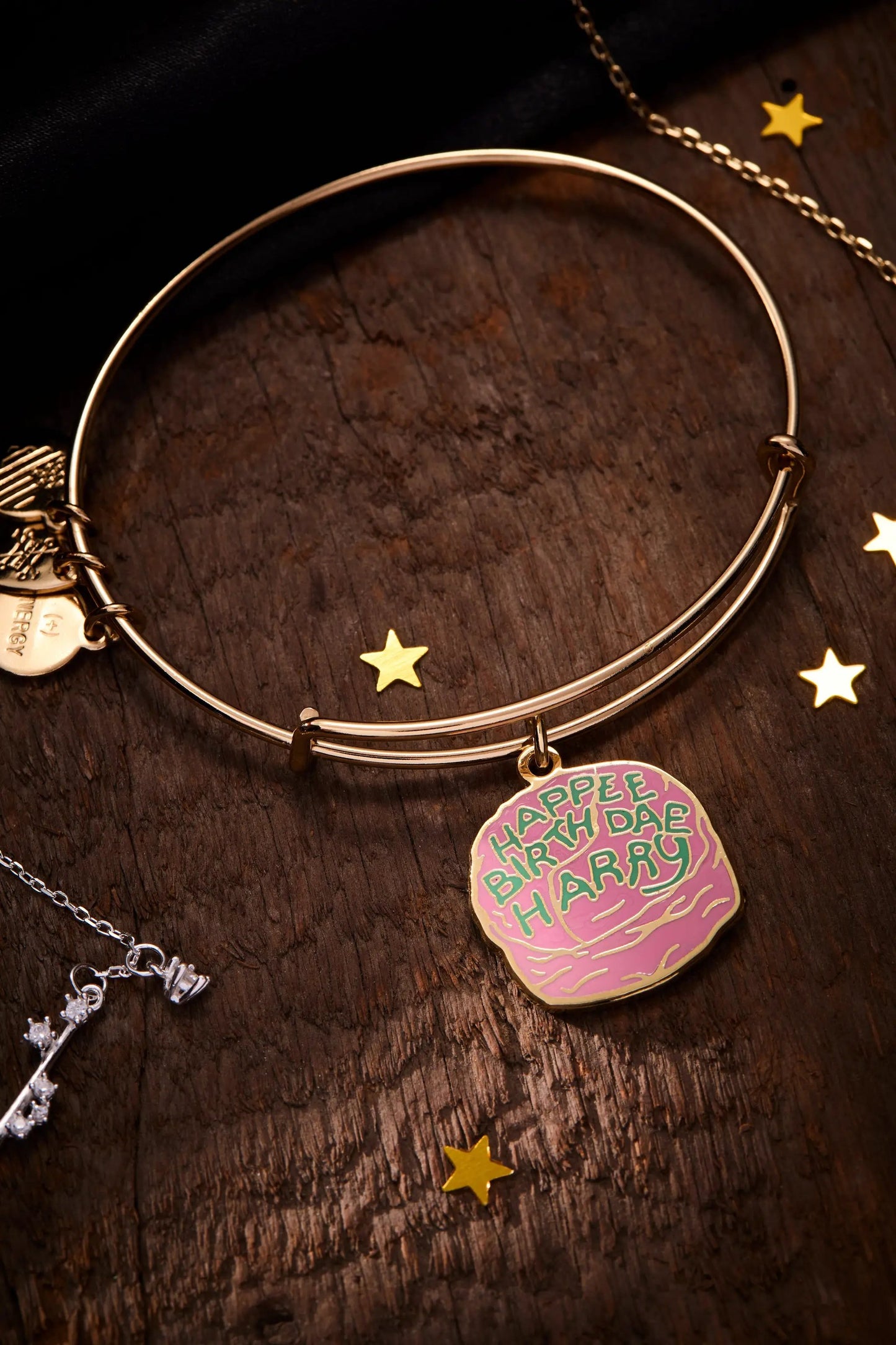 Harry Potter Celebrate Cake Charm Bangle by Alex and Ani, gold-tone with pink cake charm on Tampa Home & Garden Store