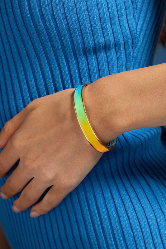 Crayola Rainbow Gradient Cuff bracelet in rainbow enamel with gold-tone edge on the wrist on Tampa Home & Garden Store