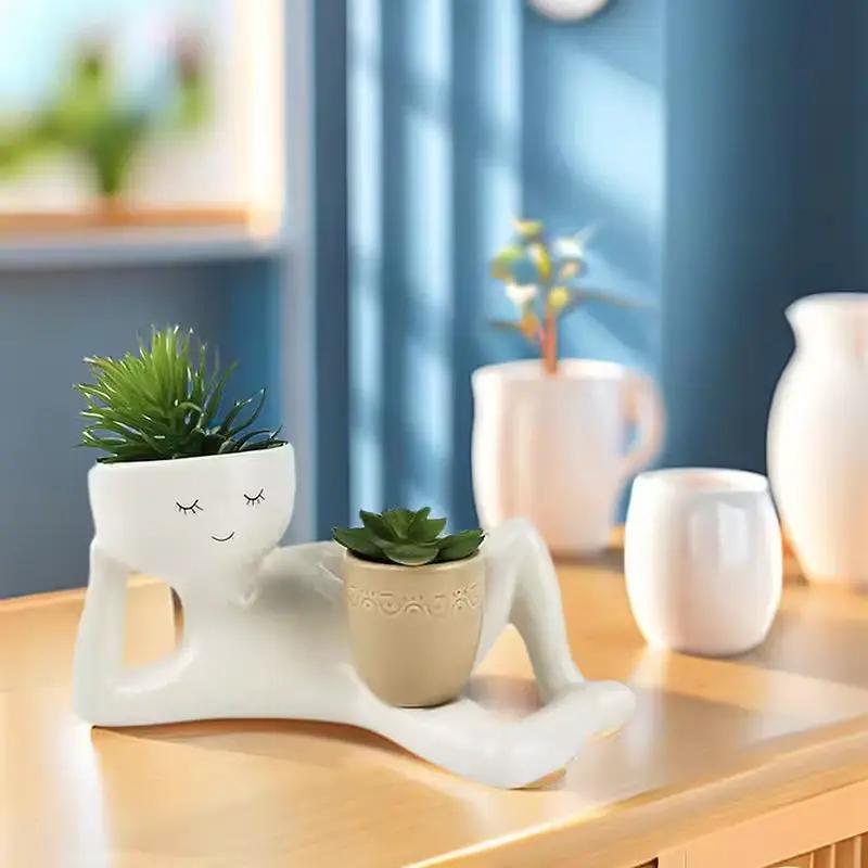 White resin funny succulent pot planter with drainage hole, kneeling figure holding beige pot on Tampa Home & Garden Store