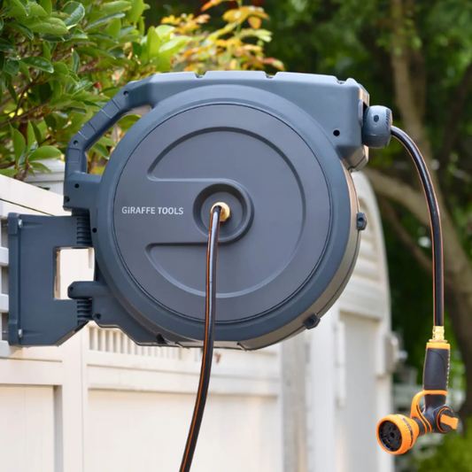 Retractable Garden Hose Reel by Giraffe Tools in gray with auto rewind mounted outdoors on Tampa Home & Garden Store