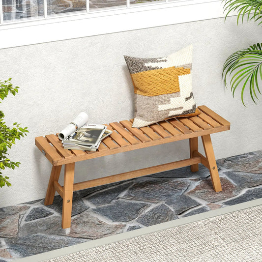 Acacia wood outdoor garden bench for two with slatted seat and yellow-orange pillow on Tampa Home & Garden Store