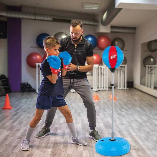 Adjustable punching bag on stand with blue base, blue/red striped ball and gloves in gym on Tampa Home & Garden Store