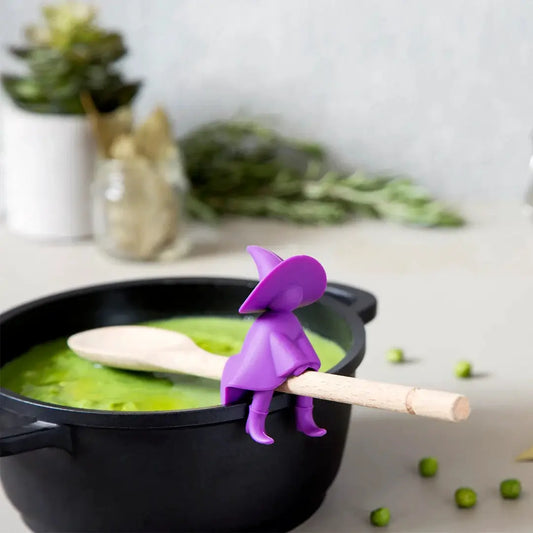 Agatha spoon holder and steam releaser by OTOTO DESIGN in purple silicone on pot rim on Tampa Home & Garden Store