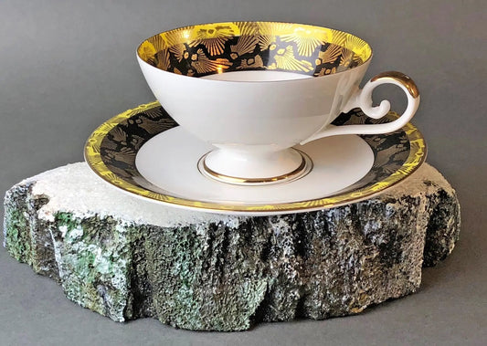 Antique Bavarian porcelain tea cup and saucer with black and gold floral interior and gold rim on Tampa Home & Garden Store