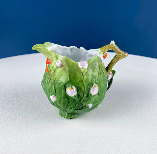 Antique bisque porcelain creamer in emerald green with pink and white raised spots and a ruffled rim on Tampa Home & Garden Store