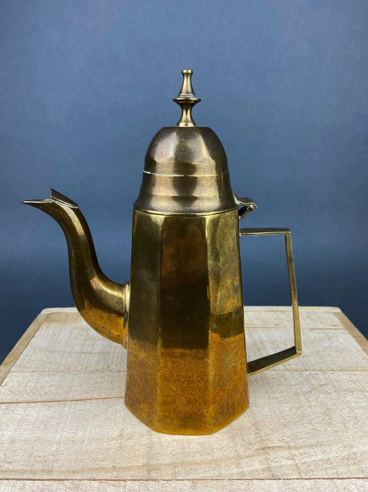 Antique brass coffee pot with tall domed lid, curved spout and handle on a wooden surface on Tampa Home & Garden Store