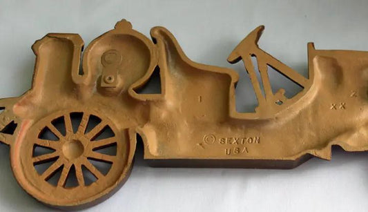 Antique cast metal yellow car wall hanging by Sexton USA, vintage rustic home decor on Tampa Home & Garden Store