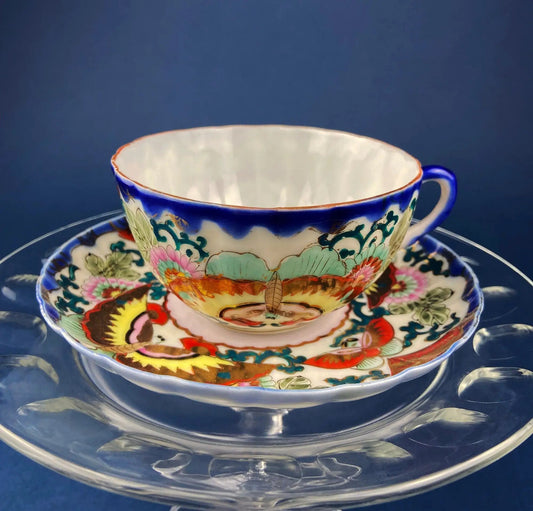 Antique hand-painted tea cup with Asian motif, blue rim, vibrant floral porcelain on Tampa Home & Garden Store