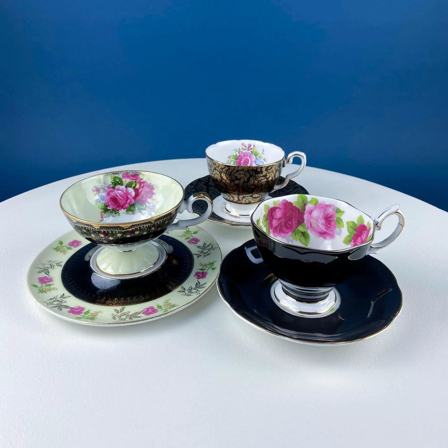 Antique Lefton teacup and saucer set, black and gold with pink rose motifs on Tampa Home & Garden Store
