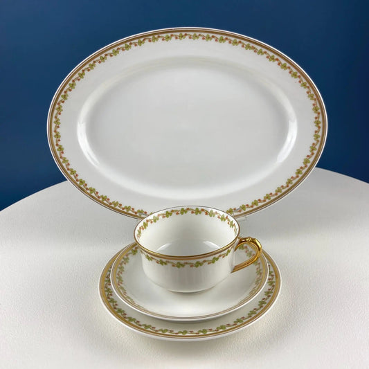 Antique Limoges porcelain tea set with clover trim; gilt-rimmed plates and matching cups and saucers on Tampa Home & Garden Store