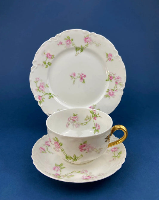 Antique Limoges tea cup and saucer set with pink rose motif on white porcelain on Tampa Home & Garden Store