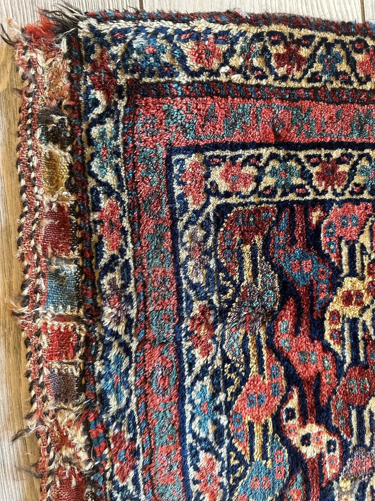 Antique Kurdish square hanging rug with red, blue, and cream floral motifs on Tampa Home & Garden Store