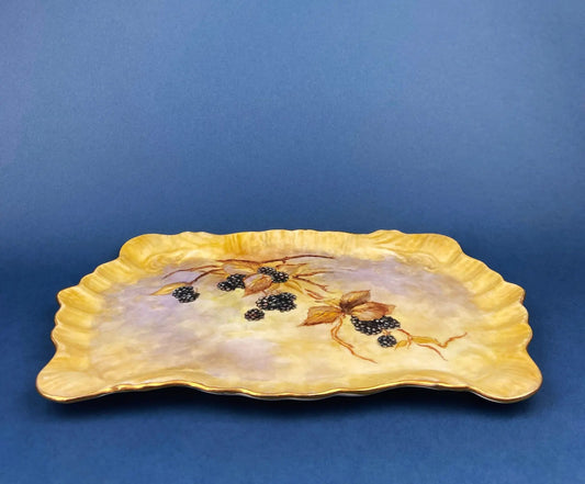 Two antique porcelain decorative trays with yellow scalloped rims and grape motif on Tampa Home & Garden Store