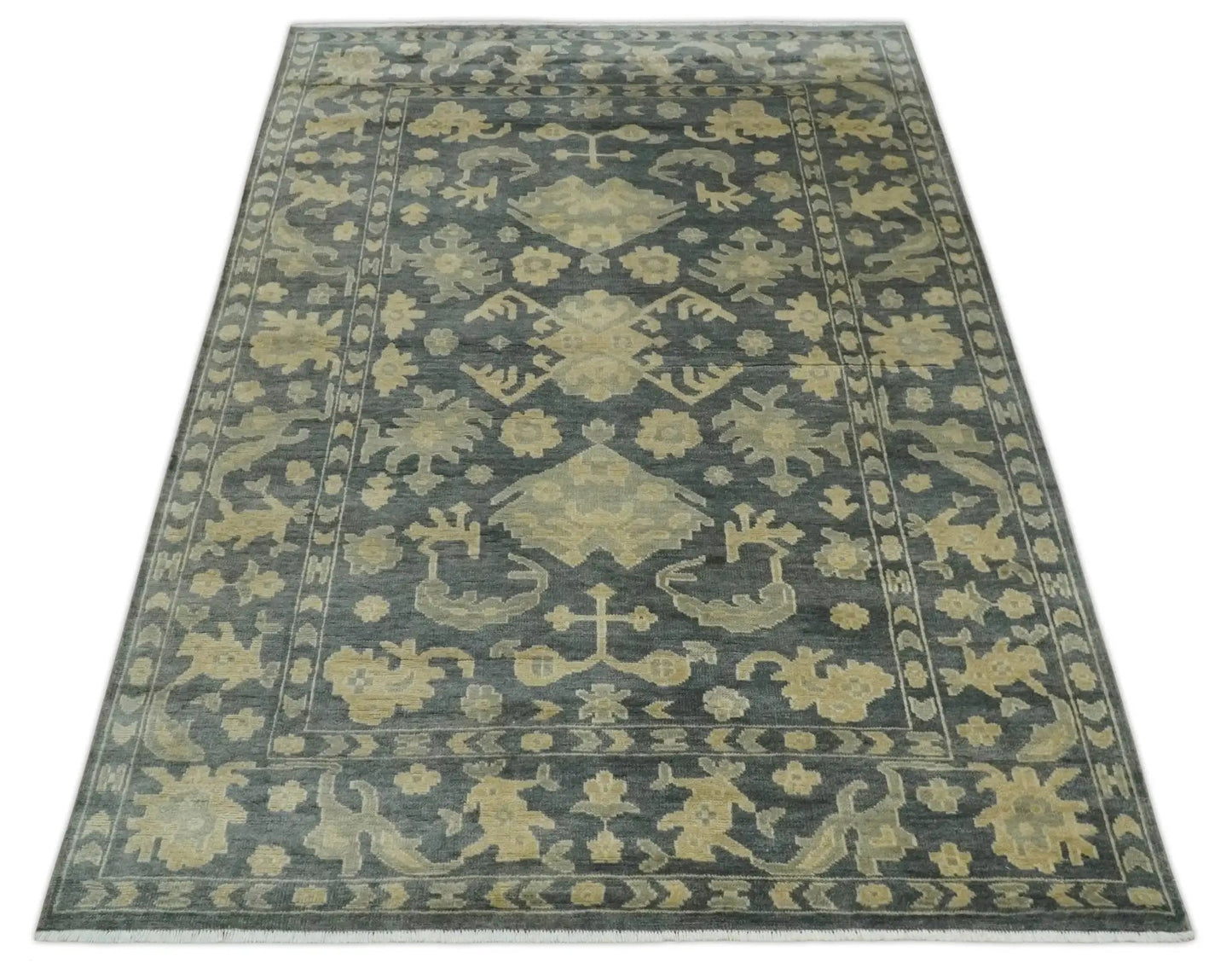 Antique hand-knotted wool area rug beige and charcoal with a medallion and ornate border on Tampa Home & Garden Store