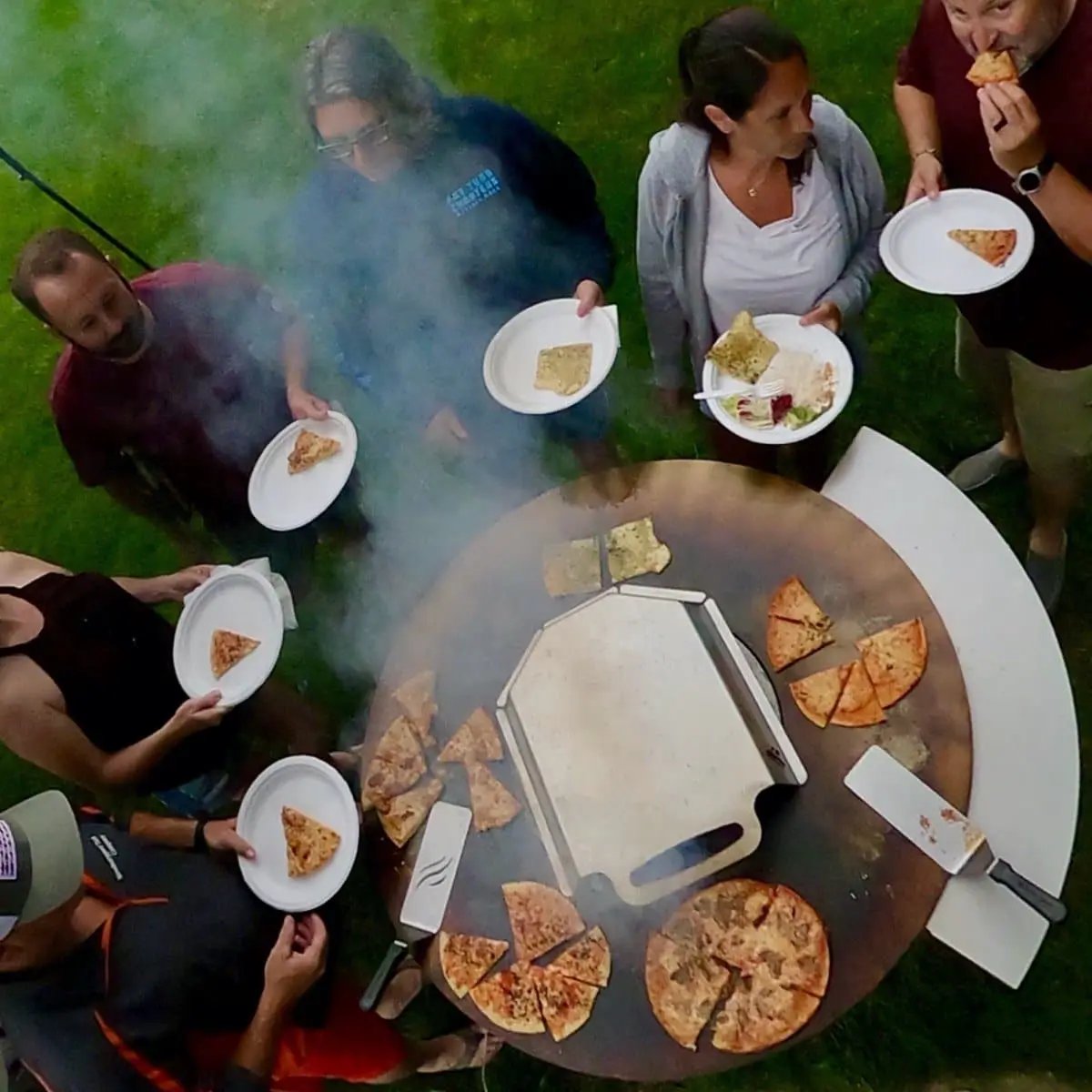 Arteflame Pizza Oven Kit for Grills on round outdoor grill with multiple pizzas on Tampa Home & Garden Store