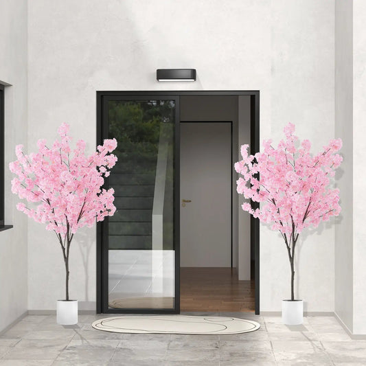 Pair of 6.5 ft artificial cherry blossom trees with 900 pink flowers in white pots by glass door on Tampa Home & Garden Store