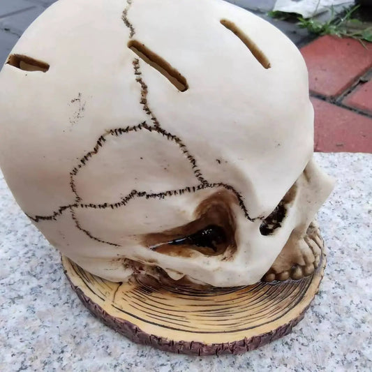 Cream skull Halloween ornament with stitched seams and hollow eye slits on a wooden disk base on Tampa Home & Garden Store