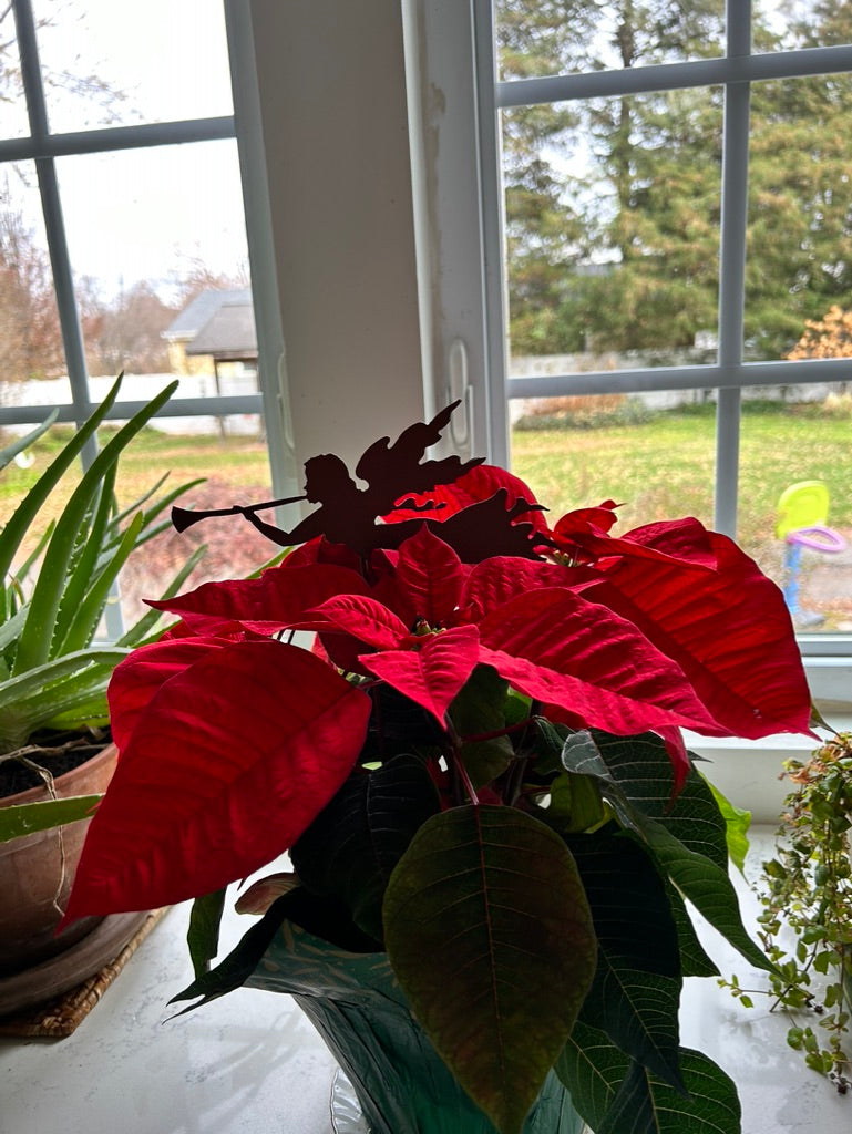 Angel Plant Stake / Angel Memorial metal silhouette among red poinsettias in a pot on Tampa Home & Garden Store