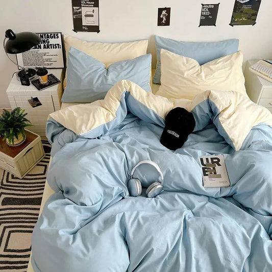 Washed cotton solid color four piece bedding set in pastel blue and ivory on bed on Tampa Home & Garden Store
