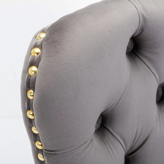 Gray velvet bar stool arm with gold stud accents along seam on Tampa Home & Garden Store