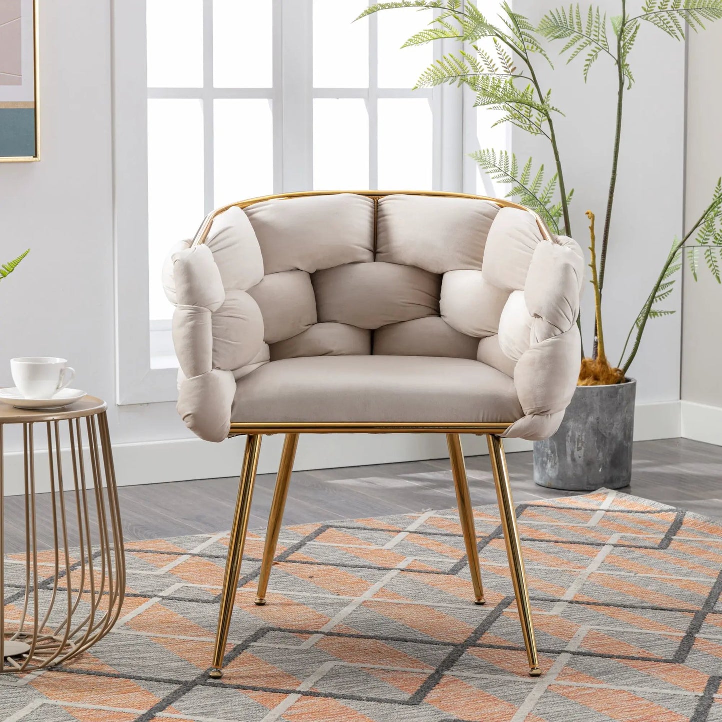 Beige velvet single armchair with tufted cushions and gold metal legs in a modern room on Tampa Home & Garden Store