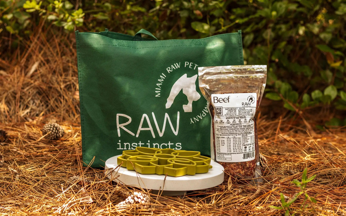 Raw PMR Beef Meal Blend for Cats and Dogs with a green Raw Instincts bag outdoors on Tampa Home & Garden Store