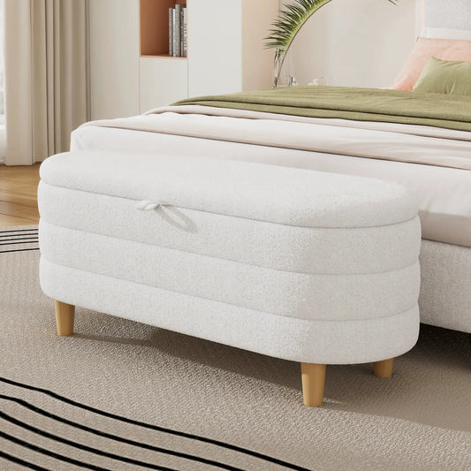 Pair of round cream Sherpa storage ottomans with wood legs in a bedroom setting on Tampa Home & Garden Store