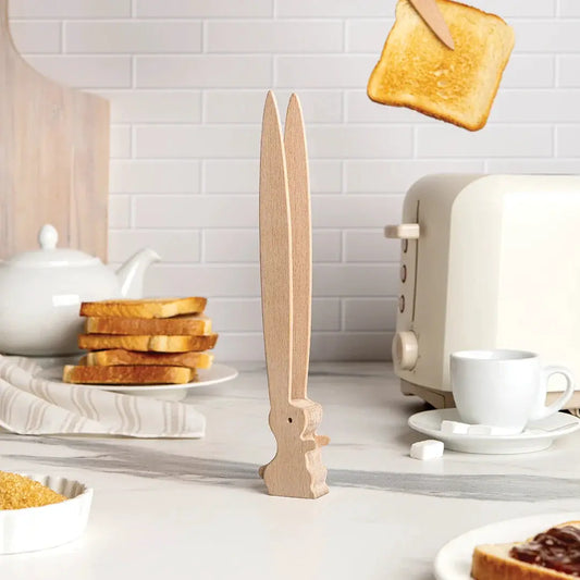 Bernie Tongs by Ototo, natural wood kitchen tongs with a tall carved base on a white counter on Tampa Home & Garden Store