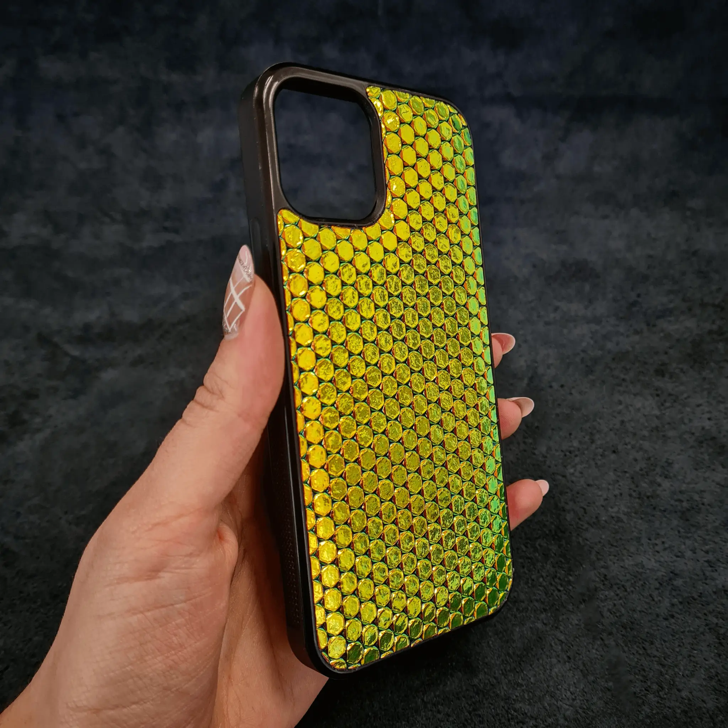 Bestia D Albertis leather phone case with iridescent yellow-green scale texture and brown frame on Tampa Home & Garden Store