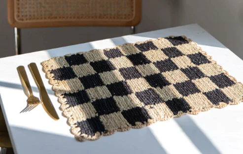 Black checked raffia placemat by Payton James, rectangular tabletop accessory on white table on Tampa Home & Garden Store