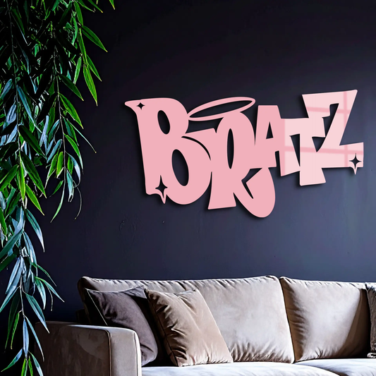 Bratz logo metal wall art in pink letters, retro decor on dark wall above gray sofa and plant on Tampa Home & Garden Store