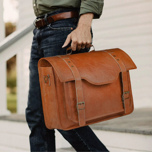 Goat leather messenger bag with brass hardware in tan brown, front buckle straps on Tampa Home & Garden Store