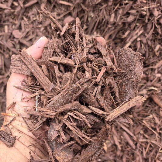 Brown mulch close up in my hand.