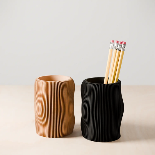 Bubbly pencil holders; two tan and black ribbed holders; pencils in the black holder on Tampa Home & Garden Store