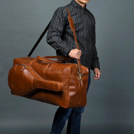 Buffalo Leather Tennis Duffle Bag for Travel with tan strap carried by man in dark plaid shirt on Tampa Home & Garden Store