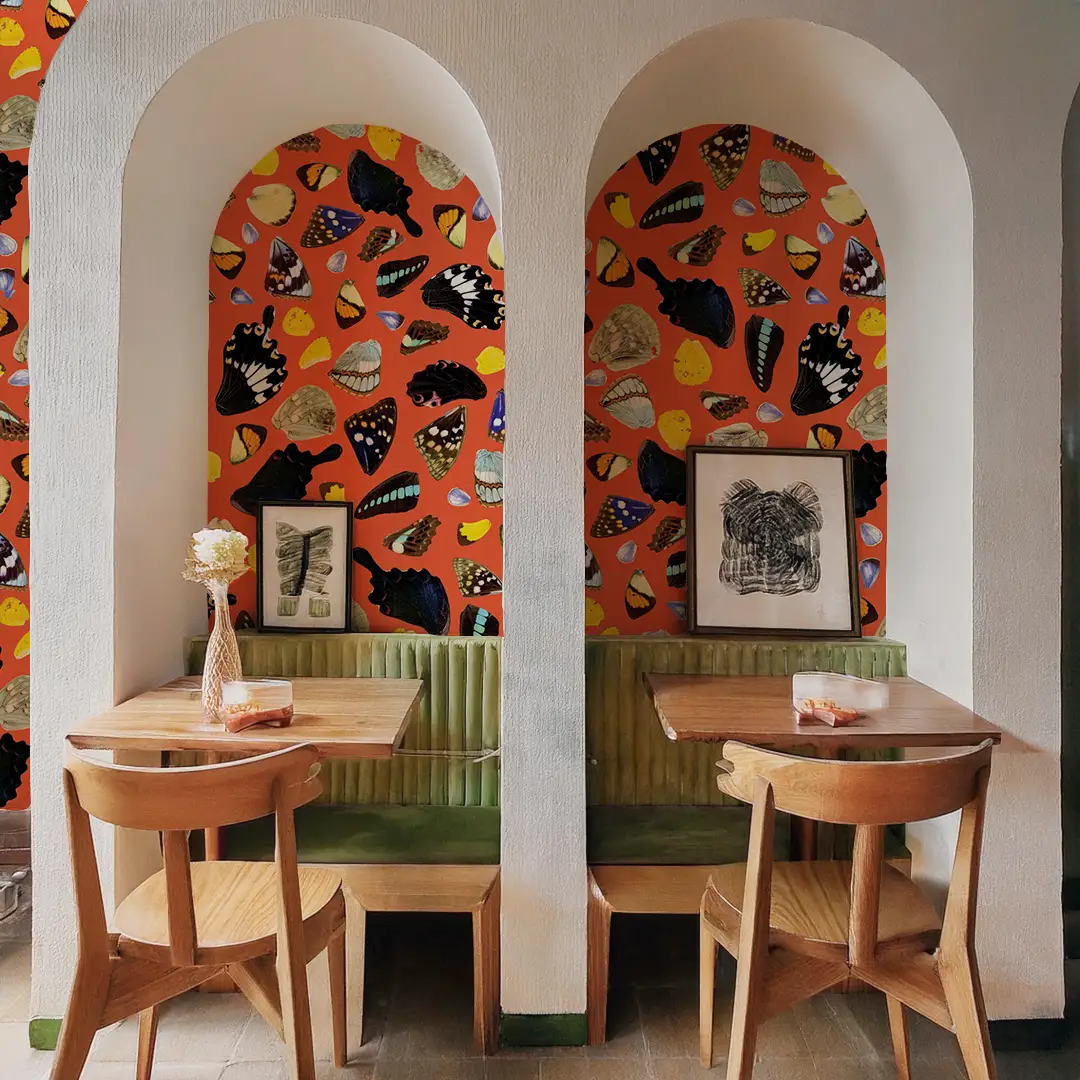 Butterfly Terrazzo Wallpaper orange with butterfly motifs in arched alcove cafe setting on Tampa Home & Garden Store