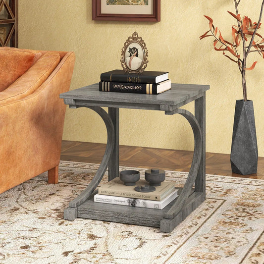C-shaped 24-inch grey end table with two tiers beside sofa, top stack of books and ornate frame on Tampa Home & Garden Store