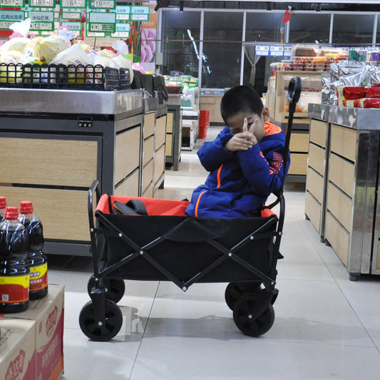 Folding wagon garden shopping cart with black frame and orange fabric in a store aisle on Tampa Home & Garden Store
