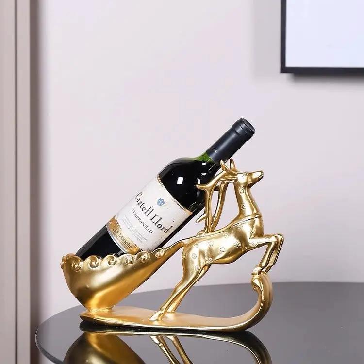 Golden deer wine rack sculpture in metallic finish holding a wine bottle for living room decor on Tampa Home & Garden Store