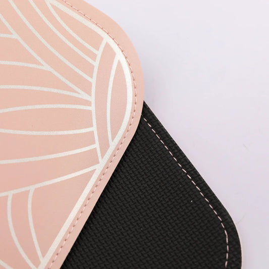 Pink round handbag with white geometric pattern and pink stitched edge, black strap visible on Tampa Home & Garden Store